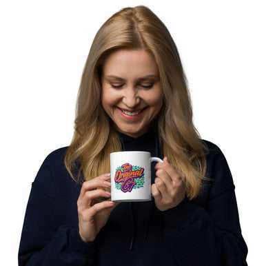 Mug featuring The Original G in colorful retro lettering on a white ceramic body with a glossy finish and handle.