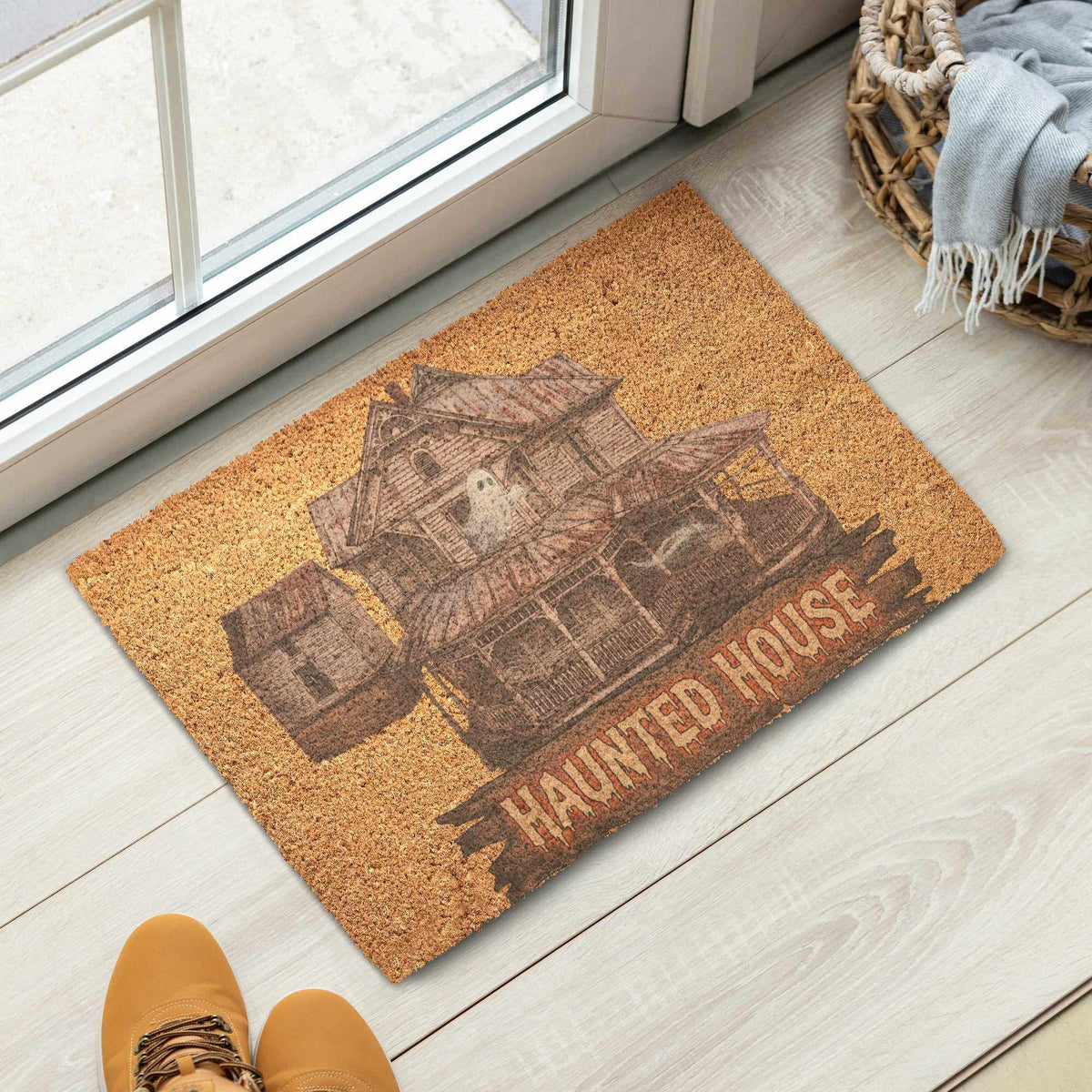 Haunted House - Coir Doormat in natural tan coir with a dark haunted house illustration and lettering