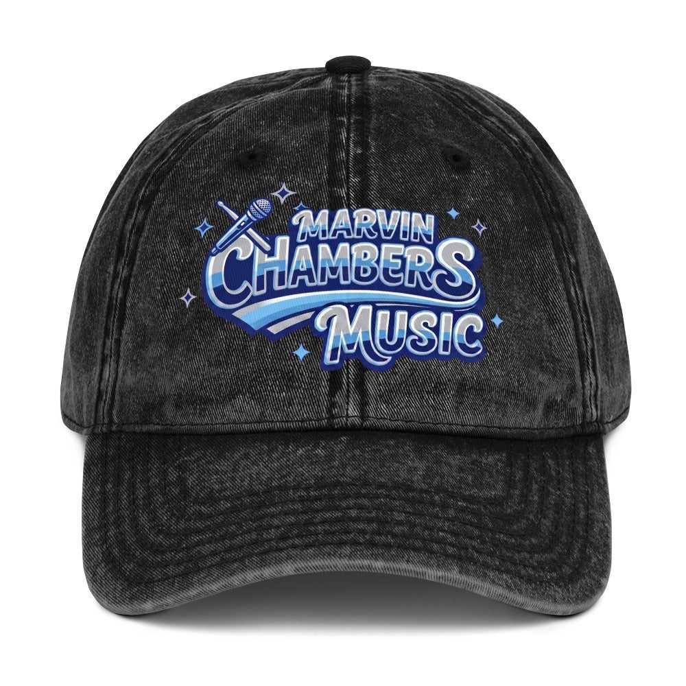 Vintage Twill Cap in washed black denim-style twill with a curved brim and blue, white, and silver music graphic